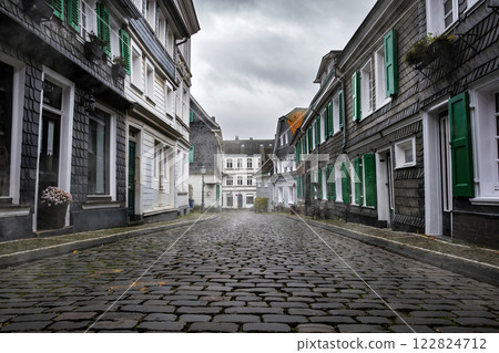 Paving Stones Road in Hazy morning with Traditional Slate houses in Greafrath, Germany 122824712