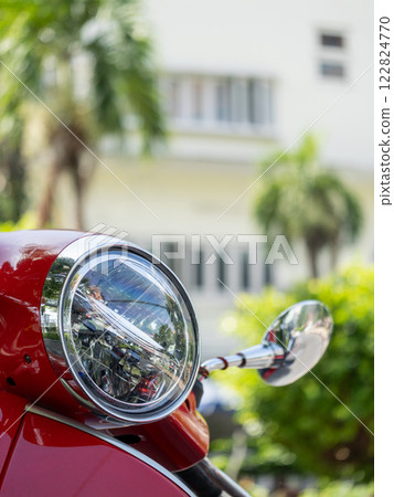 Vibrant red scooter close-up urban park sunny day focused view transportation concept 122824770