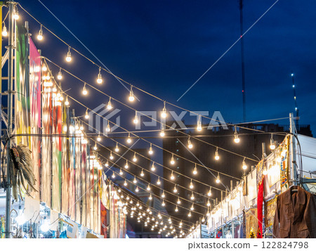 Festive night market stroll urban city evening ambiance wide angle cultural experience 122824798