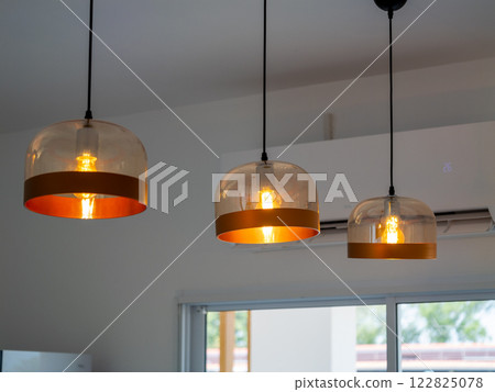 Stylish pendant lighting installation modern home interior design bright atmosphere aesthetic appeal 122825078