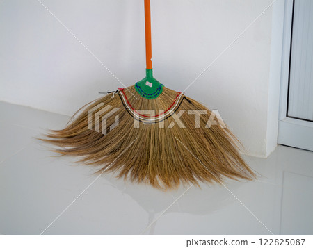 Housekeeping action cleaning with a broom indoor space home environment close-up view daily chores 122825087