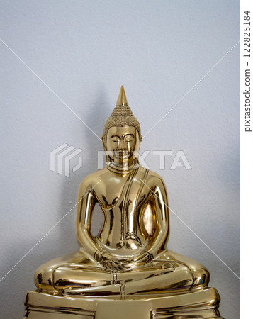 Golden buddha statue artistic representation in a contemporary tranquil indoor environment 122825184