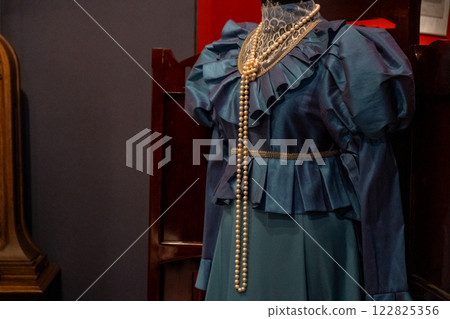 Old pearl beads on a blue dress Old pearl beads on a blue dress 122825356