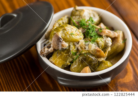 Brussel sprouts stewed in sour cream sauce with mushrooms and spices 122825444