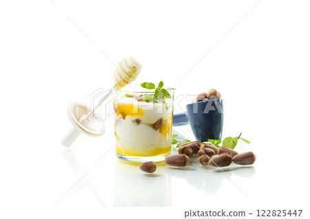 homemade yogurt with kiwi, honey and nuts in a glass, isolated on white background 122825447