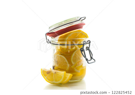 sliced lemons in sugar syrup in a glass jar, canned sliced lemons in sugar syrup in a glass jar, canned 122825452