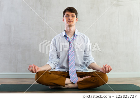Yoga for office workers - man practicing yoga in office 122825727
