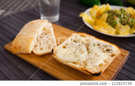 Toasted italian ciabatta bread with melted cheese and provencal herbs Toasted italian ciabatta bread with melted cheese and provencal herbs 122825736