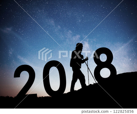 Silhouette young hiker man for 2018 new year background of the Milky Way galaxy on a bright star dark sky tone 122825856