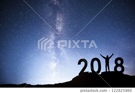 Silhouette young man Happy for 2018 new year background of the Milky Way galaxy on a bright star dark sky tone 122825860