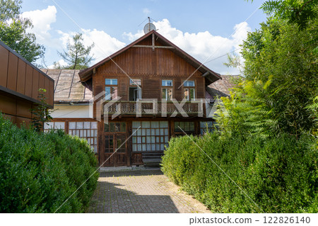 Wooden balcony of a wood house. Exterior facade. 122826140