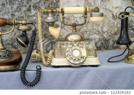 Old phone. A disk with numbers, a tube on a wire. First prototype. 122826163