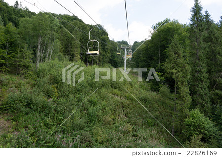 Cableway to the top of the Carpathian Mountains. Hills and forest. Nature in summer Cableway to the top of the Carpathian Mountains. Hills and forest. Nature in summer 122826169