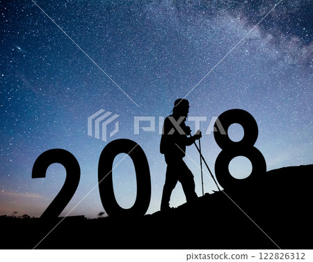 Silhouette young hiker man for 2018 new year background of the Milky Way galaxy on a bright star dark sky tone 122826312