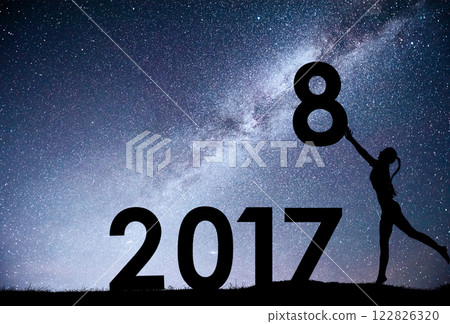 Silhouette young girl. Happy 2018 new year. Background of the Milky Way galaxy on a bright star dark sky tone. Concept change year 2017 to 2018 Silhouette young girl. Happy 2018 new year. Background of the Milky Way galaxy on a bright star dark sky tone. Concept change year 2017 to 2018 122826320