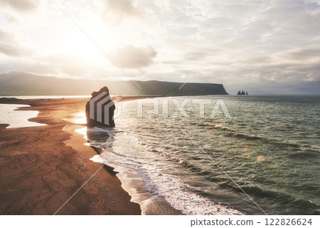 The black sand beach and mountains Reynisfjara from Cape at sunset in Iceland The black sand beach and mountains Reynisfjara from Cape at sunset in Iceland 122826624