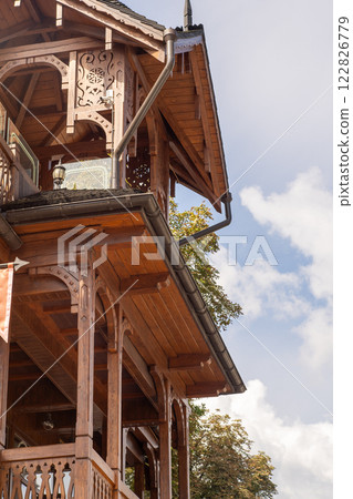 Wooden balcony of a wood house. Exterior facade 122826779