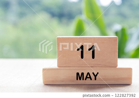 11 May text on wooden blocks with customizable space for text or messages. Month and copy space concept 122827392