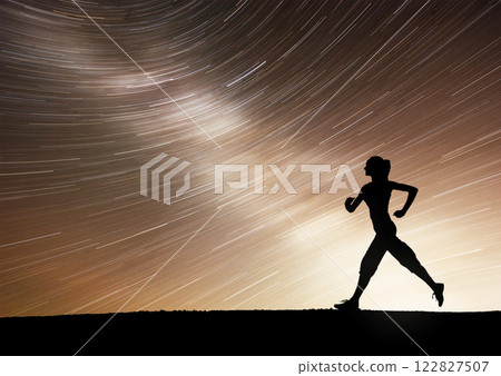 A sports girl at dawn is engaged in yoga. Fitness classes at starry sky A sports girl at dawn is engaged in yoga. Fitness classes at starry sky 122827507