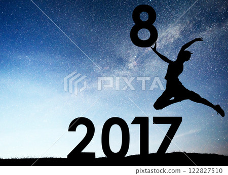 Silhouette young girl. Happy 2018 new year. Background of the Milky Way galaxy on a bright star dark sky tone. Concept change year 2017 to 2018 122827510