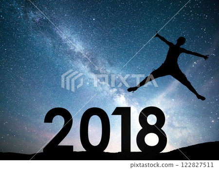 Silhouette young girl. Happy 2018 new year. Background of the Milky Way galaxy on a bright star dark sky tone Silhouette young girl. Happy 2018 new year. Background of the Milky Way galaxy on a bright star dark sky tone 122827511