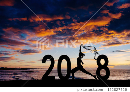 Silhouette young woman jumping to 2018 new year 122827526