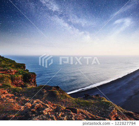 The black sand beach and mountains Reynisfjara from Cape at sunset in Iceland The black sand beach and mountains Reynisfjara from Cape at sunset in Iceland 122827794