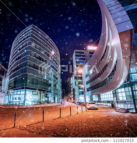 Panorama of the night city of Dusseldorf in winter during a snowstorm. Bokeh light effect, soft filter 122827818
