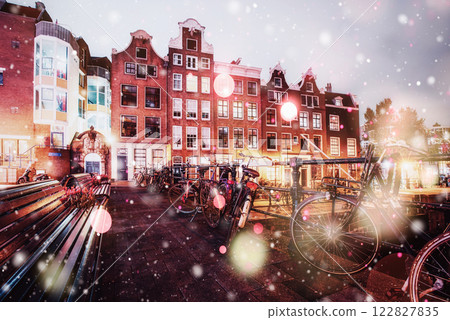 Beautiful calm night view of Amsterdam city during a snowstorm. Bokeh light effect, soft filter Beautiful calm night view of Amsterdam city during a snowstorm. Bokeh light effect, soft filter 122827835