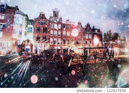 Beautiful calm night view of Amsterdam city during a snowstorm. Bokeh light effect, soft filter 122827836