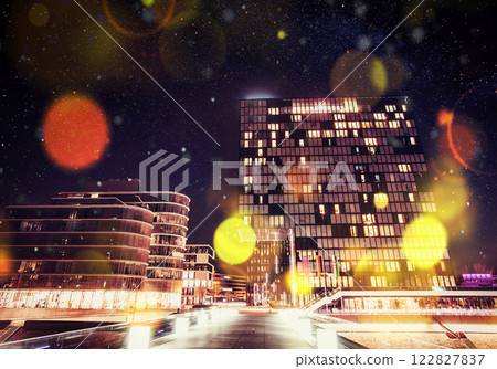 Panorama of the night city of Dusseldorf in winter during a snowstorm. Bokeh light effect, soft filter 122827837