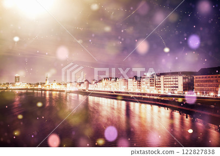 Panorama of the night city of Dusseldorf in winter during a snowstorm. Bokeh light effect, soft filter 122827838