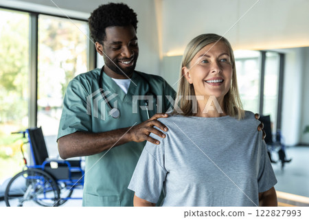 African american male doctor working on correction of female patients posture African american male doctor working on correction of female patients posture 122827993