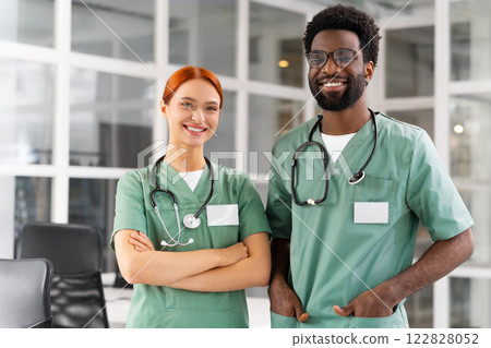 Diverse team of doctors and healthcare professionals posing together in clinic Diverse team of doctors and healthcare professionals posing together in clinic 122828052