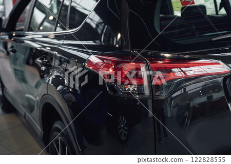 The back headlights of a black luxury car The back headlights of a black luxury car 122828555