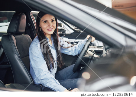 auto business, car sale, consumerism and people concept - happy woman taking car key from dealer in auto show or salon 122828614