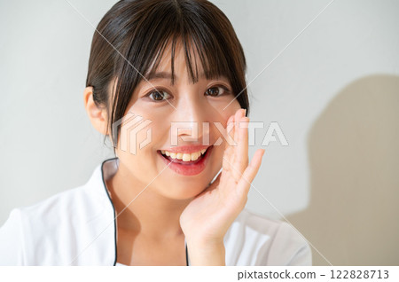 Smiling Japanese woman whispering Smiling Japanese woman whispering 122828713