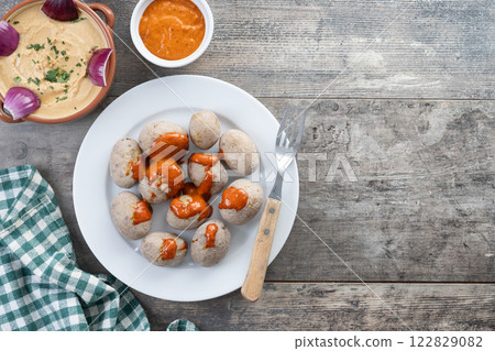 Papas arrugadas with mojo and gofio escaldado on wooden table. Traditional Canary Islands food. 122829082