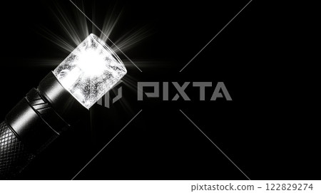 Illuminated flashlight in night 122829274