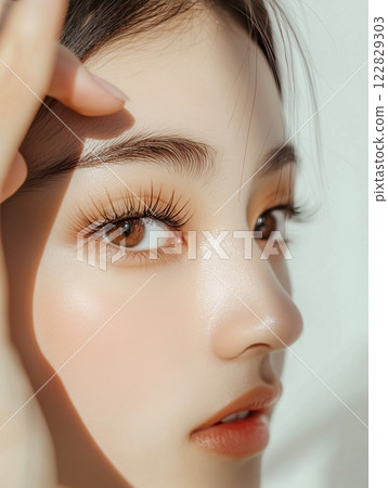 Close-up of beautiful young Asian woman's eyes | Beauty portrait with long and beautiful eyelashes Close-up of beautiful young Asian woman's eyes | Beauty portrait with long and beautiful eyelashes 122829303