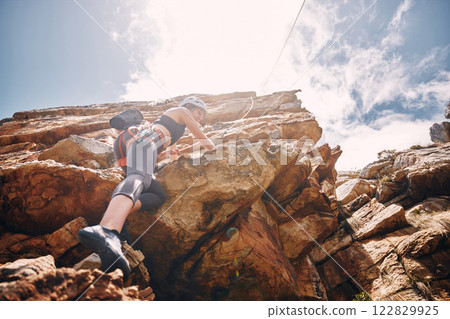 Fitness, extreme sports and rock climbing woman on a mountain, enjoy a climb in nature and freedom. Athlete, adrenaline and energy with female on adventure, physical challenge exercise cliff hanging Fitness, extreme sports and rock climbing woman on a mountain, enjoy a climb in nature and freedom. Athlete, adrenaline and energy with female on adventure, physical challenge exercise cliff hanging 122829925