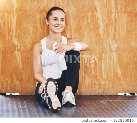 Fitness woman gym break, water bottle and healthy after workout, exercise and sports training in wellness club. Happy, smile and motivation athlete drinking for rest, thirsty and strong body refresh 122830016