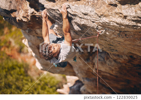 Climbing rock, mountain and man training for health in nature, doing adventure challenge on holiday travel and sport fitness workout on vacation in Canada. Strong athlete doing cardio on cliff 122830025