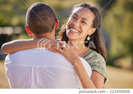 Love, hug and couple in park or green garden, summer sunshine and smile portrait. Adventure, wellness and romance wife woman embrace husband on valentines day anniversary or honeymoon nature getaway 122830098
