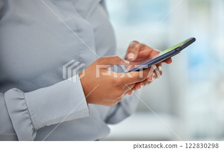 Phone, hands and communication with a business woman networking with wifi technology in her office at work. Closeup of a female employee reading, typing or sending a text message on her mobile 122830298