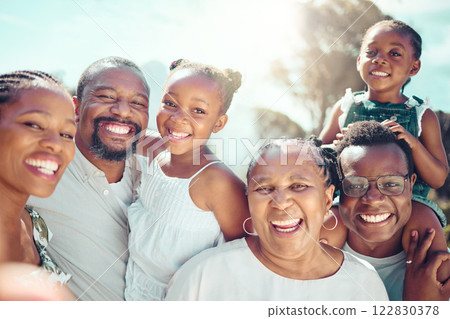 Portrait, happy black big family and love as they smile on vacation, trip or holiday. Ancestry, African people or grandparent, fathers and mother with kids together in the shining sun or sunshine. 122830378