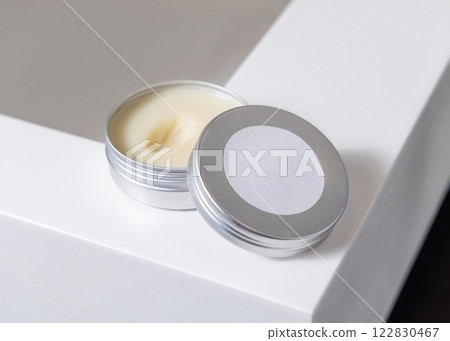 Opened body butter jar with blank label on lid on white basin close up, cosmetic mockup Opened body butter jar with blank label on lid on white basin close up, cosmetic mockup 122830467