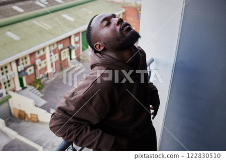 Depression, mental health and anxiety for sad man suffering from life problem stress on balcony of home apartment. Depressed black person face with negative mindset, pain and frustrated over failure 122830510