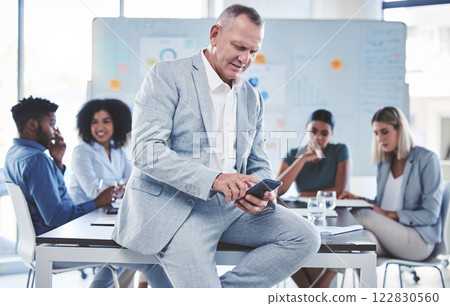 Leadership, business and a ceo on his phone in meeting with team of corporate men and women. Senior manager, coaching and internet research for office presentation in workshop with a business coach. 122830560