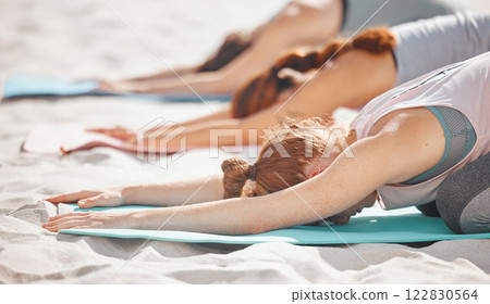 Beach yoga, fitness women and balasana stretching, kneeling and balance in extended childs pose. Exercise, peace and healthy workout for energy, mind wellness and zen training on summer sand seashore 122830564